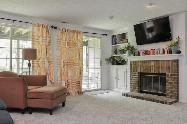 living room with carpet, healthy amount of natural light, a fireplace, and a textured ceiling