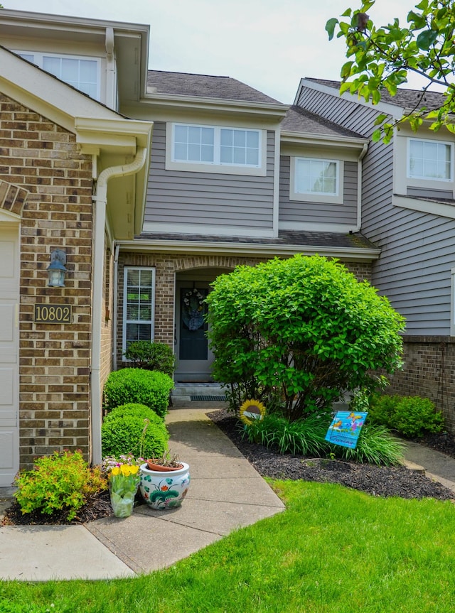 doorway to property featuring brick siding