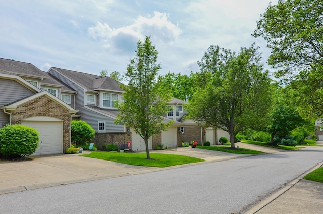 view of front of home with brick siding, driveway, and a garage
