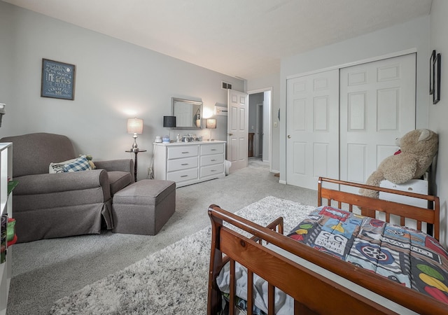 bedroom featuring light colored carpet and a closet