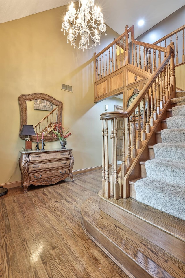 9015 Washington Trace Rd, California, KY 41007 - stairs featuring a chandelier, wood finished floors, a high ceiling, and recessed lighting