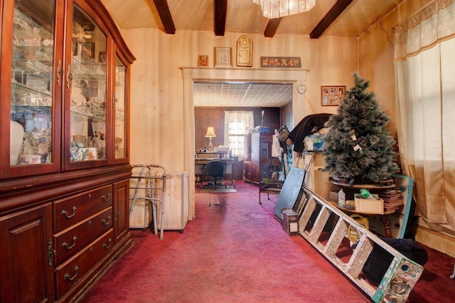hall with dark carpet and beamed ceiling