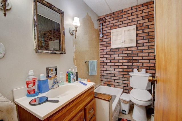 bathroom with toilet, a tub to relax in, and vanity