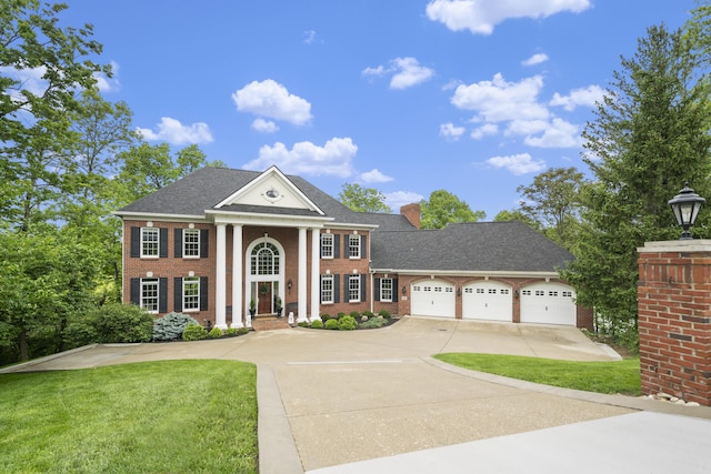 26 Abi Ln, Fort Thomas, KY 41075 - neoclassical home with concrete driveway, brick siding, a garage, and a front yard