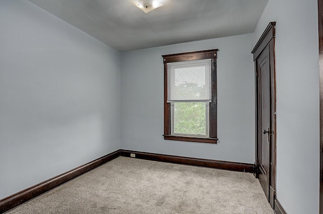unfurnished bedroom featuring carpet floors and baseboards