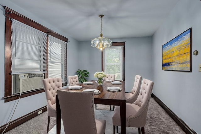 dining area featuring a chandelier, baseboards, cooling unit, and carpet flooring