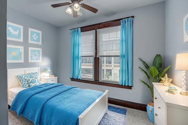 bedroom featuring carpet, baseboards, and a ceiling fan