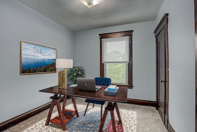 carpeted office space with baseboards
