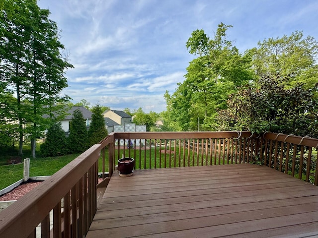 wooden deck featuring a yard