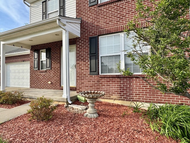 property entrance featuring brick siding