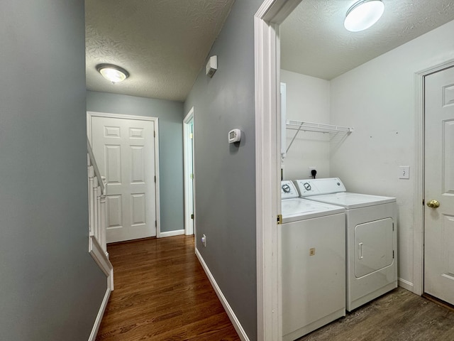 washroom featuring separate washer and dryer, wood finished floors, a textured ceiling, and baseboards