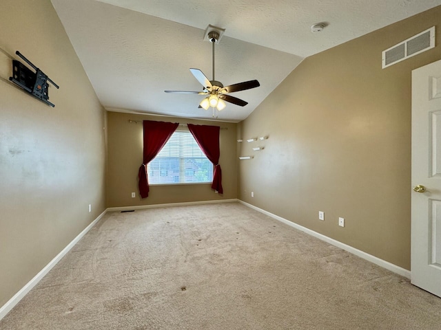unfurnished room with ceiling fan, carpet floors, lofted ceiling, a smoke detector, and baseboards