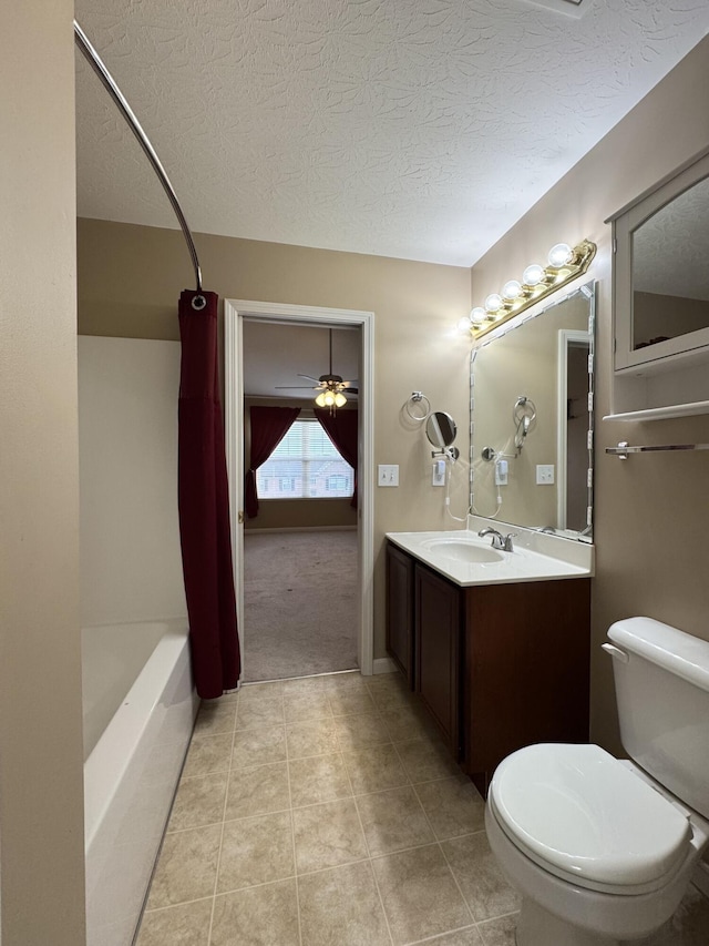 bathroom featuring toilet, a textured ceiling, vanity, tile patterned flooring, and shower / tub combo