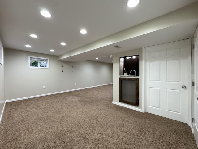 basement featuring carpet flooring, baseboards, and recessed lighting