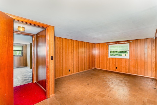 39 Buttermilk Pike, Fort Mitchell, KY 41017 - empty room with tile patterned floors, healthy amount of natural light, wood walls, and baseboards