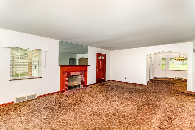 39 Buttermilk Pike, Fort Mitchell, KY 41017 - unfurnished living room with a brick fireplace, carpet flooring, baseboards, a chandelier, and arched walkways