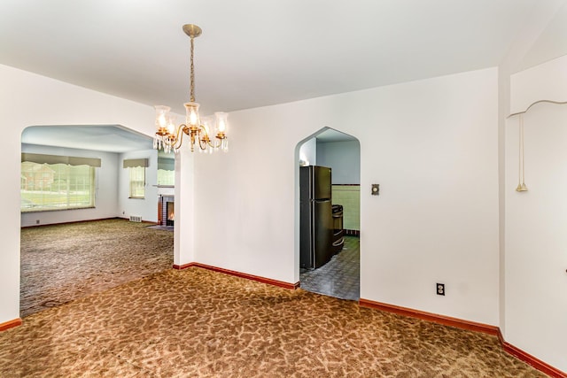 39 Buttermilk Pike, Fort Mitchell, KY 41017 - carpeted spare room featuring arched walkways, baseboards, a chandelier, and a lit fireplace