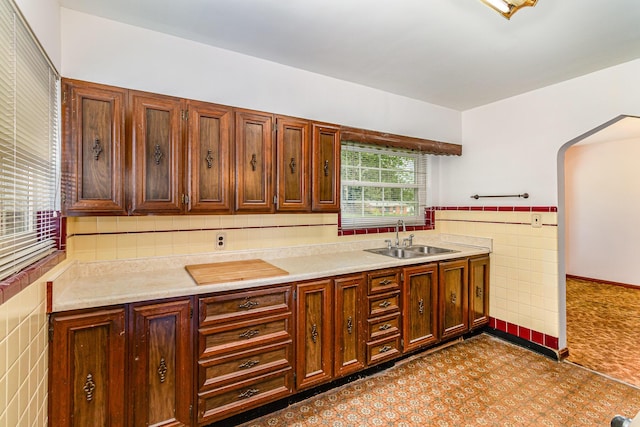 39 Buttermilk Pike, Fort Mitchell, KY 41017 - kitchen with a sink, tile walls, light countertops, and arched walkways