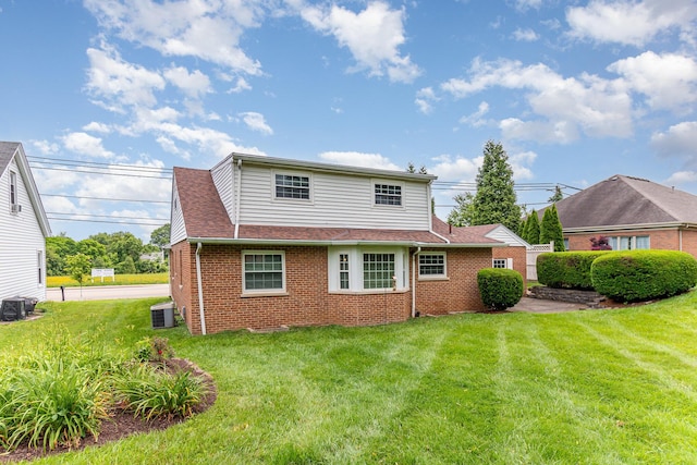 39 Buttermilk Pike, Fort Mitchell, KY 41017 - rear view of house with brick siding, central AC unit, a lawn, and roof with shingles