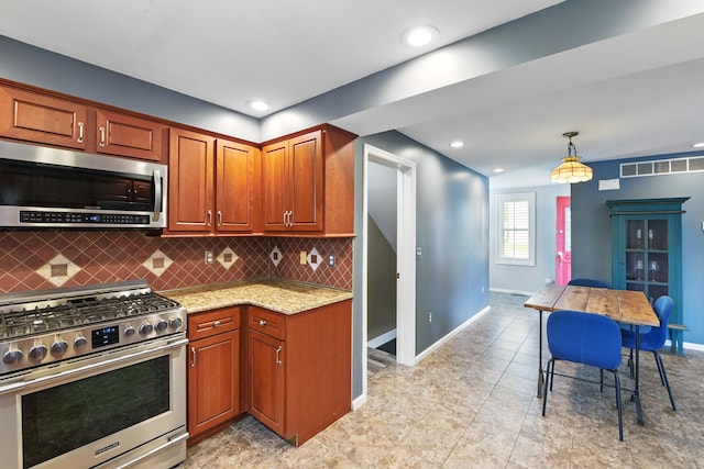 17 Harrison Ave, Bellevue, KY 41073 - kitchen with stainless steel appliances, decorative backsplash, light stone counters, baseboards, and recessed lighting