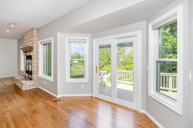 1169 Appomattox Dr, Florence, KY 41042 - unfurnished living room featuring light wood-style floors, baseboards, and a stone fireplace