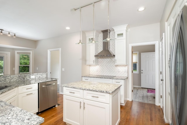1169 Appomattox Dr, Florence, KY 41042 - kitchen featuring appliances with stainless steel finishes, track lighting, wall chimney range hood, tasteful backsplash, and recessed lighting
