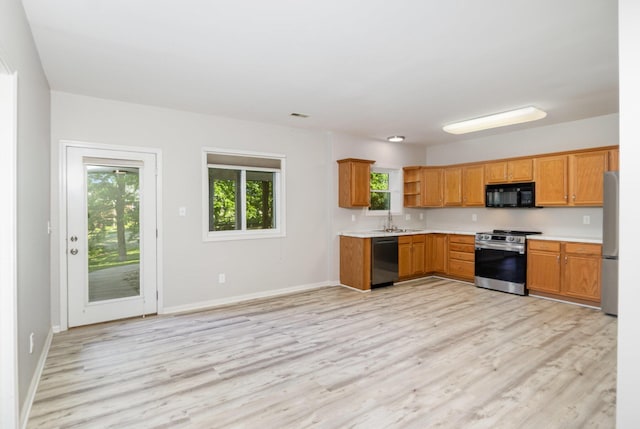 1169 Appomattox Dr, Florence, KY 41042 - kitchen with appliances with stainless steel finishes, a sink, open shelves, light countertops, and light wood-style floors