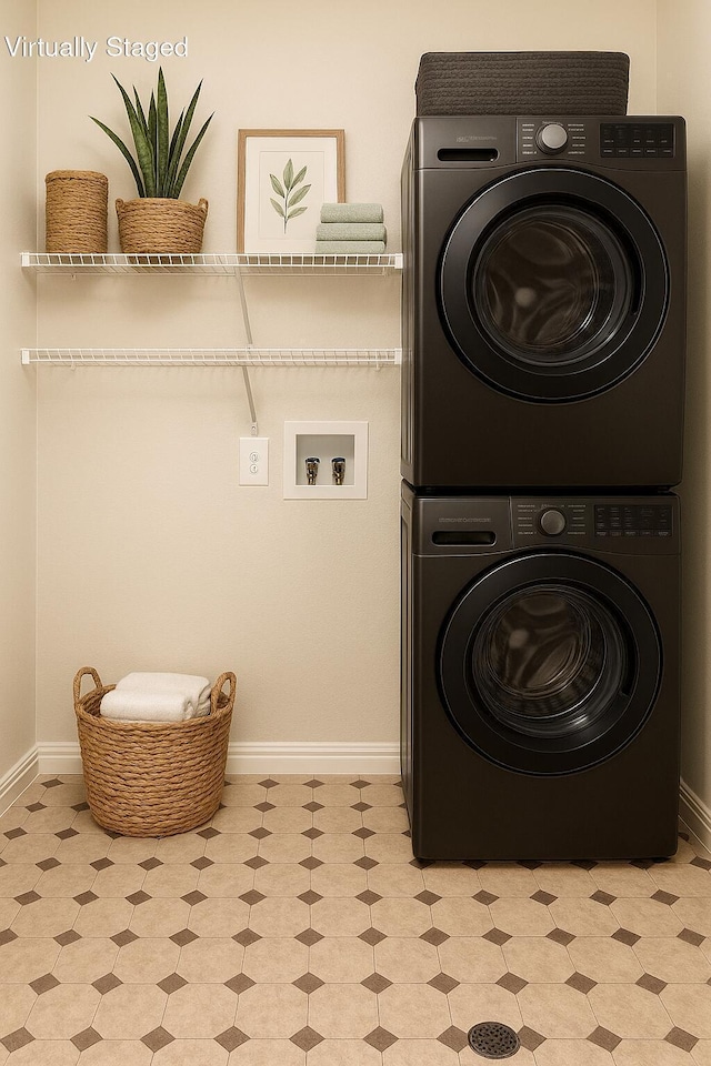 1169 Appomattox Dr, Florence, KY 41042 - laundry room with stacked washer and clothes dryer, baseboards, and light floors