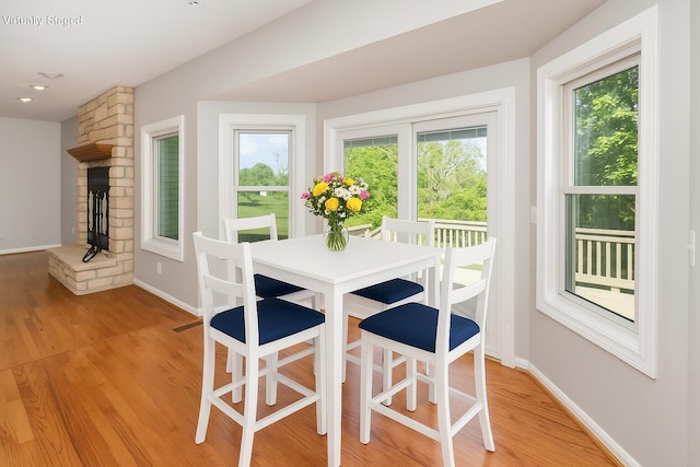1169 Appomattox Dr, Florence, KY 41042 - dining space with healthy amount of natural light, light wood finished floors, baseboards, and a large fireplace