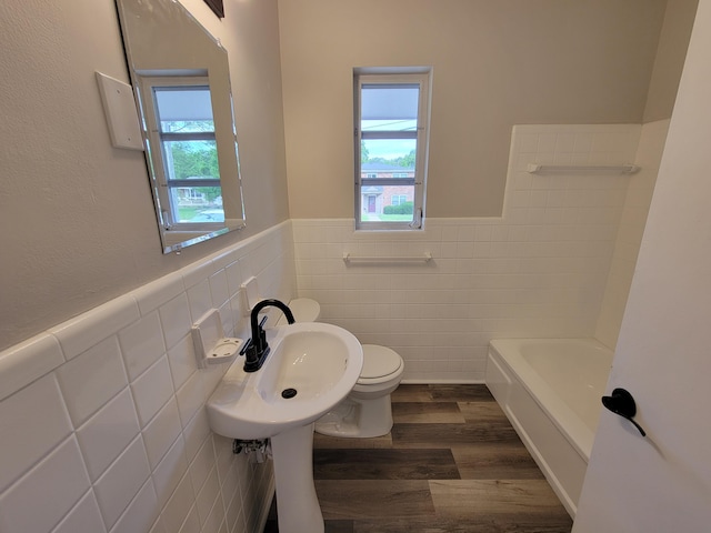 3157 Woodward St, Erlanger, KY 41018 - full bathroom with tile walls, plenty of natural light, wood finished floors, toilet, and wainscoting