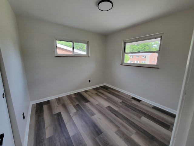 3157 Woodward St, Erlanger, KY 41018 - empty room with plenty of natural light, dark wood-style floors, and baseboards