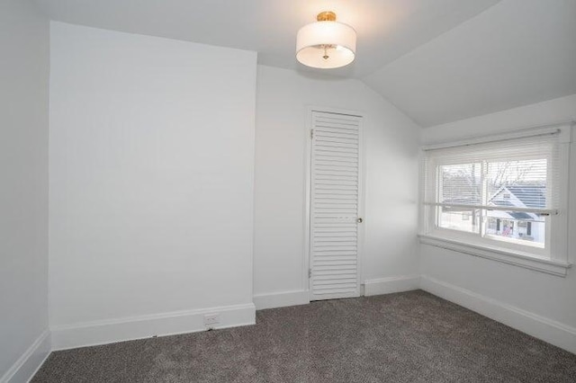2730 Dakota Ave, Covington, KY 41015 - unfurnished room featuring dark colored carpet, baseboards, and lofted ceiling