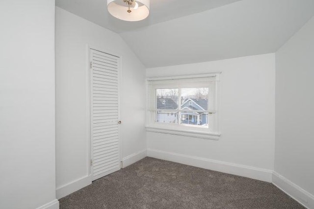 2730 Dakota Ave, Covington, KY 41015 - unfurnished bedroom featuring dark carpet, baseboards, a closet, and lofted ceiling