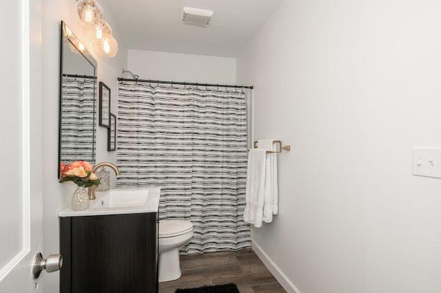 2730 Dakota Ave, Covington, KY 41015 - full bathroom with toilet, wood finished floors, vanity, baseboards, and a shower with shower curtain