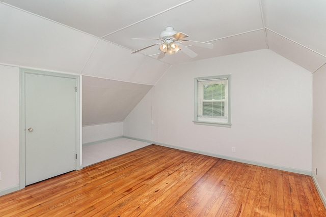 additional living space with vaulted ceiling, wood-type flooring, ceiling fan, and baseboards