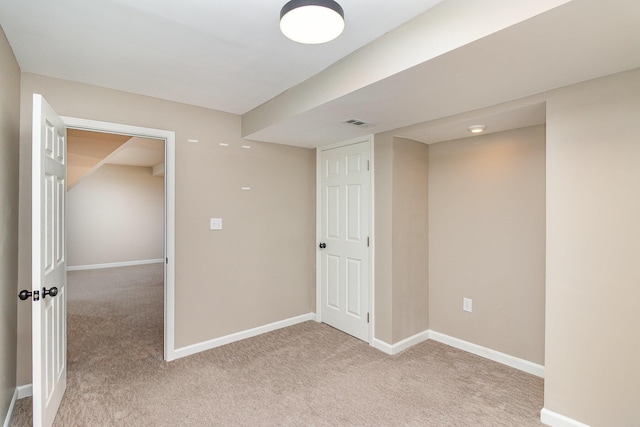 below grade area with light carpet and baseboards