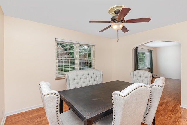 dining area featuring healthy amount of natural light, light wood-type flooring, ceiling fan, and baseboards