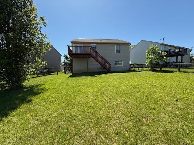 back of property with stairway and a wooden deck