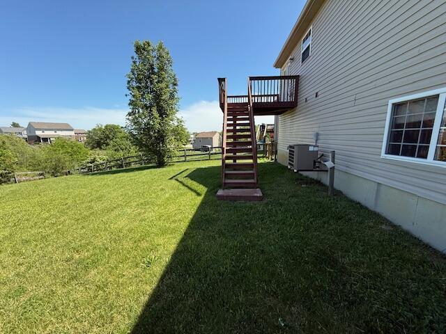 view of yard featuring stairway, a wooden deck, and cooling unit