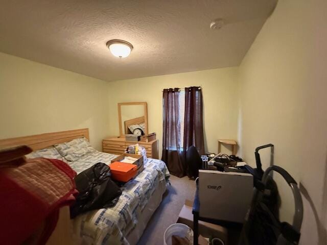 bedroom featuring carpet flooring and a textured ceiling