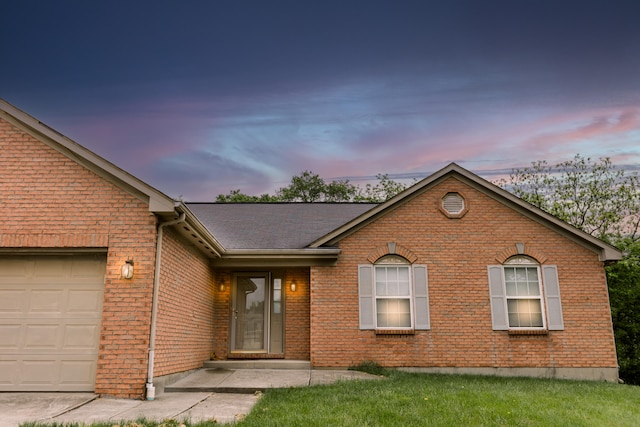 single story home featuring brick siding and an attached garage