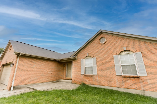 view of front of home with brick siding and an attached garage