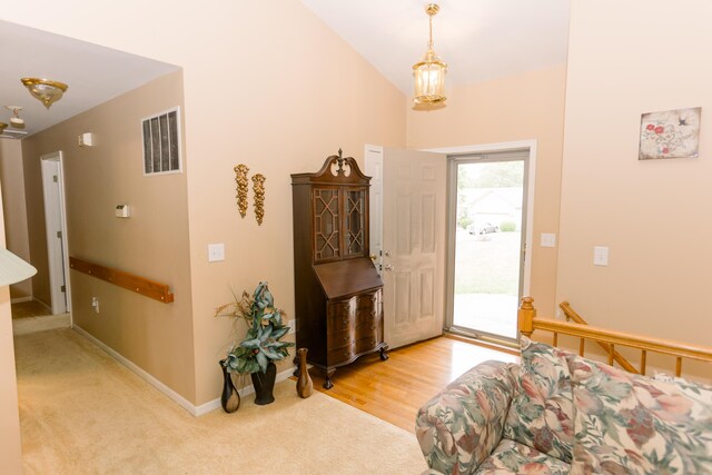 carpeted foyer entrance featuring baseboards