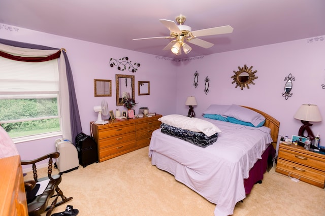 bedroom featuring light carpet and ceiling fan
