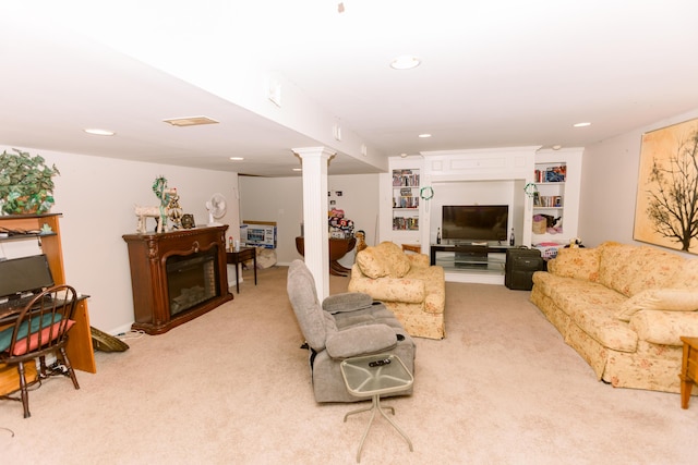 living room with light carpet, recessed lighting, ornate columns, and a glass covered fireplace
