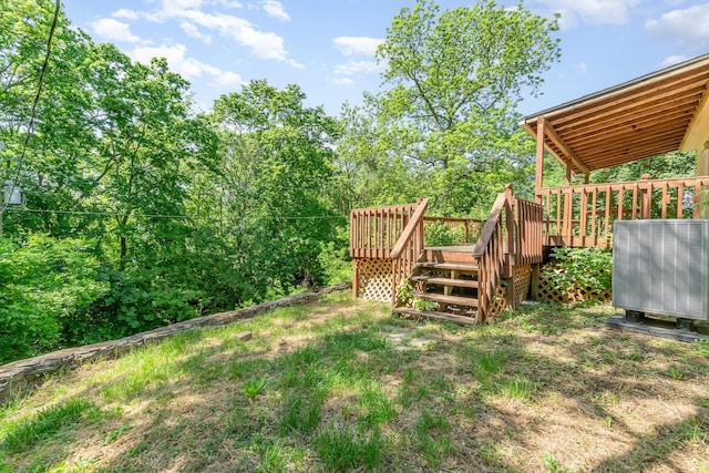 view of yard featuring a deck and central air condition unit