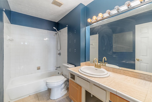 full bathroom featuring toilet, shower / washtub combination, vanity, and a textured ceiling