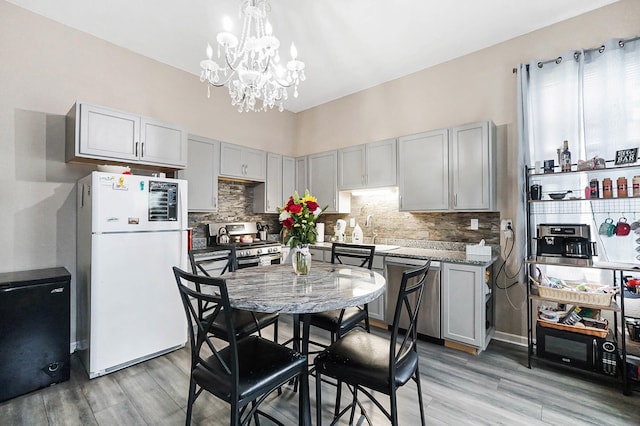 1706 Banklick St, Covington, KY 41011 - kitchen featuring appliances with stainless steel finishes, gray cabinetry, and a chandelier