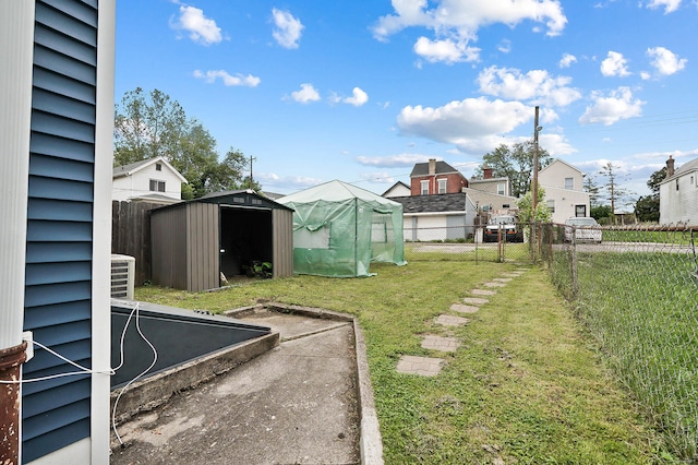 1706 Banklick St, Covington, KY 41011 - view of yard with an outbuilding, a storage shed, central AC, and a residential view
