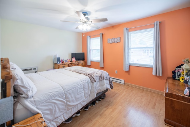 2220 Genevieve Ln, Covington, KY 41011 - bedroom featuring a baseboard heating unit, light wood-style floors, a ceiling fan, an AC wall unit, and baseboards